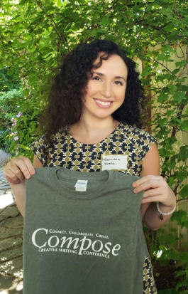 Francesca Varela holding a Compose Creative Writing Conference t-shirt.