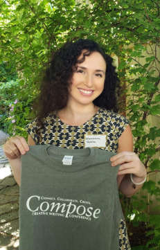 Francesa Varela holding up a Compose Creative Writing Conference t-shirt