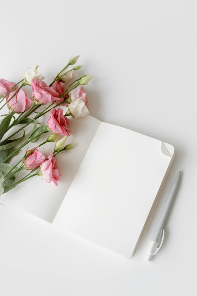 White desk and notebook that Francesca Varela uses to write environmental fiction